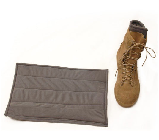 A gray padded boot protector pad shown next to a tan lace-up combat boot on a white background.