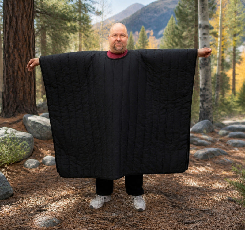 Load image into Gallery viewer, Man standing in the woods with Wiggy's Poncho with a Head hole Color Black 
