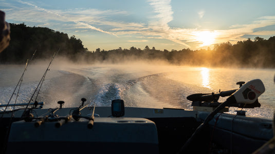 Boat on a misty lake at sunrise