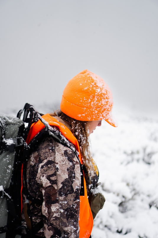 Hunter in an orange beanie in falling snow